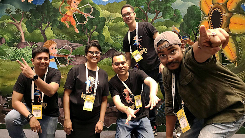 88 Pictures tackles the media production talent gap via innovative training Students in matching t-shirts and lanyards smile and wave at the camera.