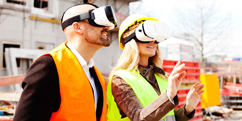 Two people wearing VR headsets on construction site