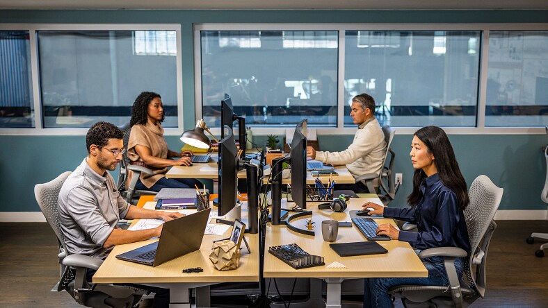 Architecture, engineering, and construction professionals working in an office