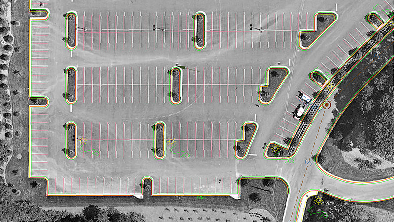 Aerial view of a parking lot highlighted with colored outlines.