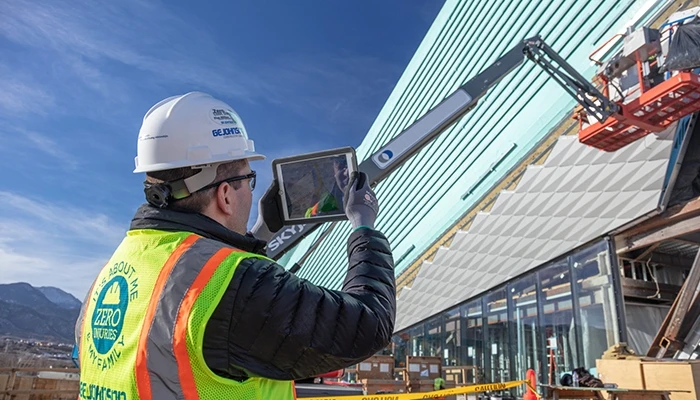 A construction worker checks materials with an iPad