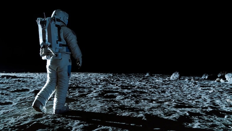 A still from The Moon shows an astronaut walking on the Moon.