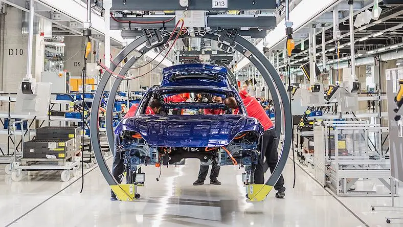 industrial engineering porsche car on factory assembly line