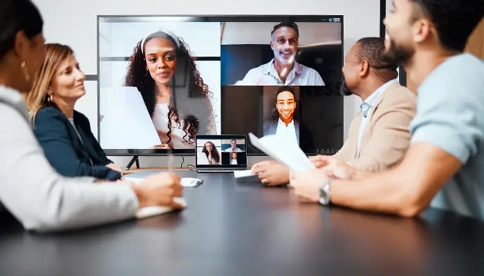 Office workers collaborate via video call