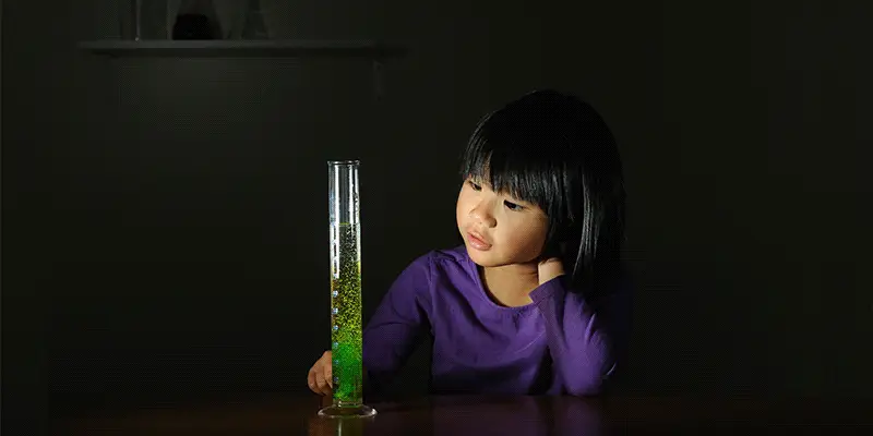 Gif of young girl looking at animated test tube STEM