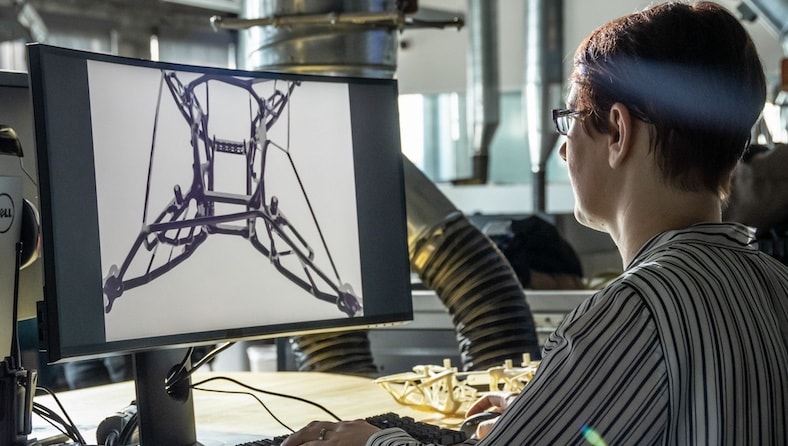 AI manufacturing woman at computer working on generative design