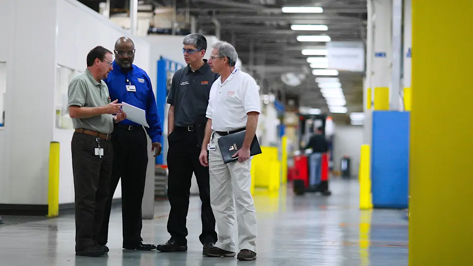 Team members speaking at a Timken plant.