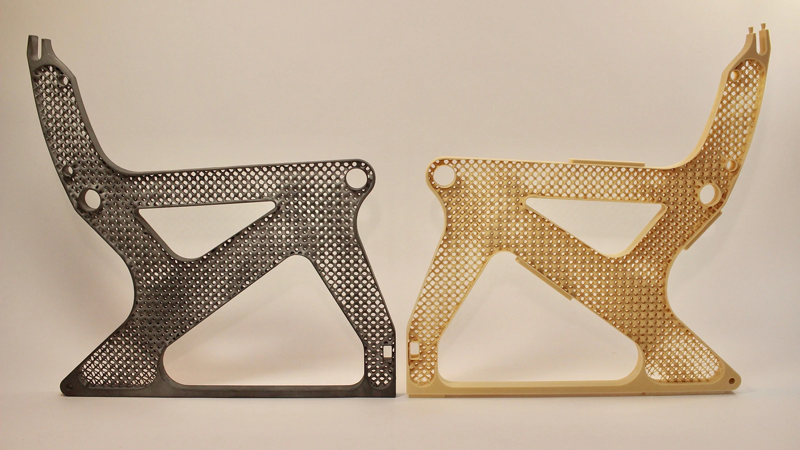 Two generatively designed metal airplane seat frames cast in metal