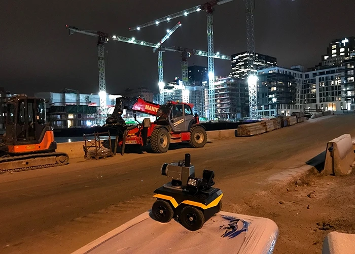 construction robot at a jobsite at nightttime