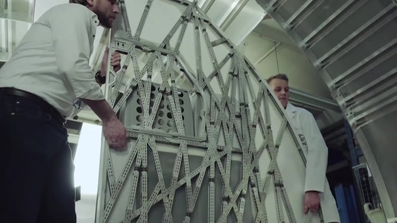 Engineers holding a bionic partition produced by Airbus