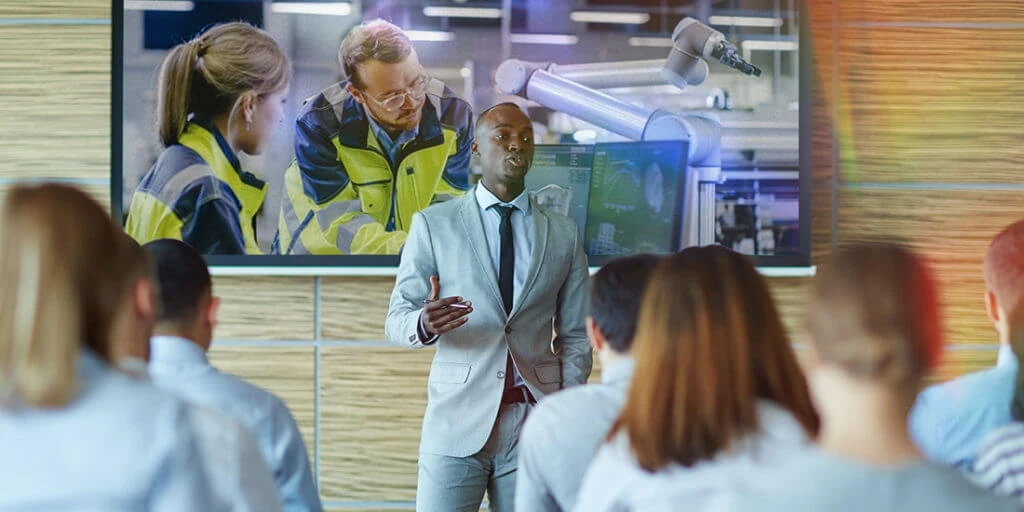 A man speaks at a construction seminar.