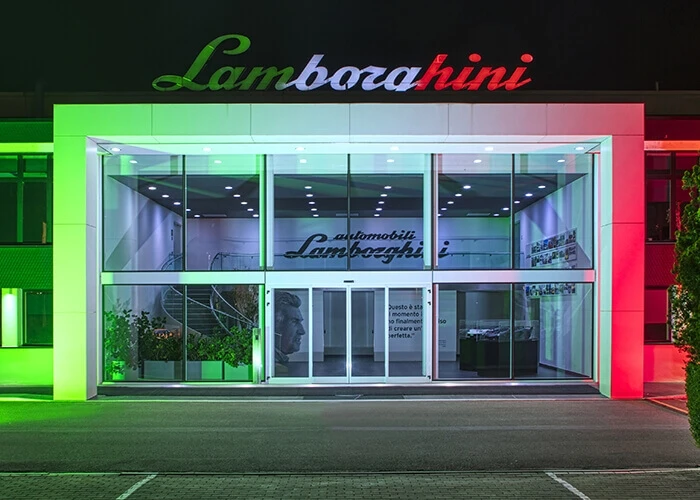 Lamborghini factory illuminated with tricolore green white red of the Italian flag