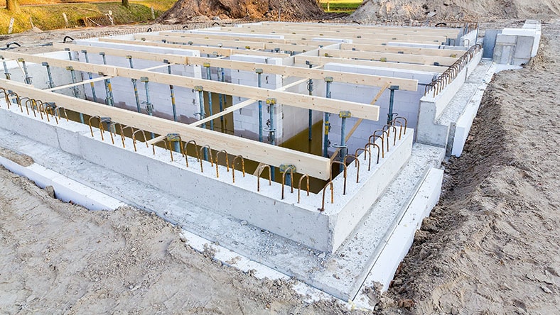 A building foundation takes shape on a construction site.