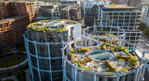 A city skyline showing skyscrapers with green roofs