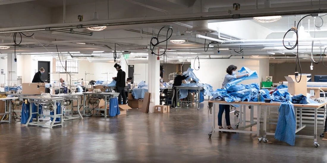 Workers sew healthcare gear in a factory