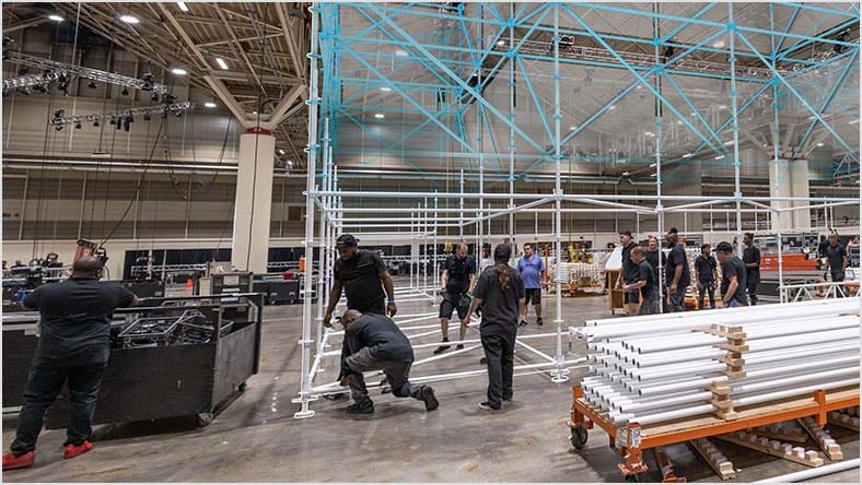Acrobats balancing on a truss