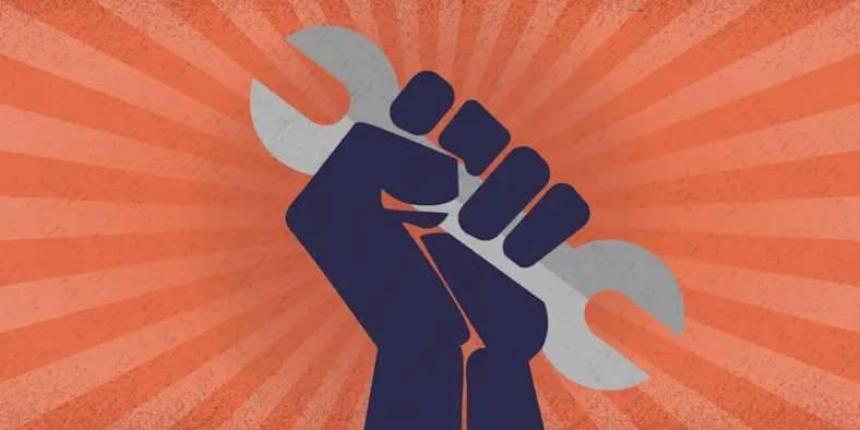 A hand holding up a wrench.