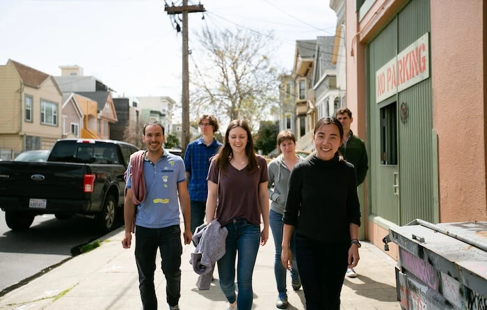 several young adults walking on a sidewalk—the low-carbon products team at treau