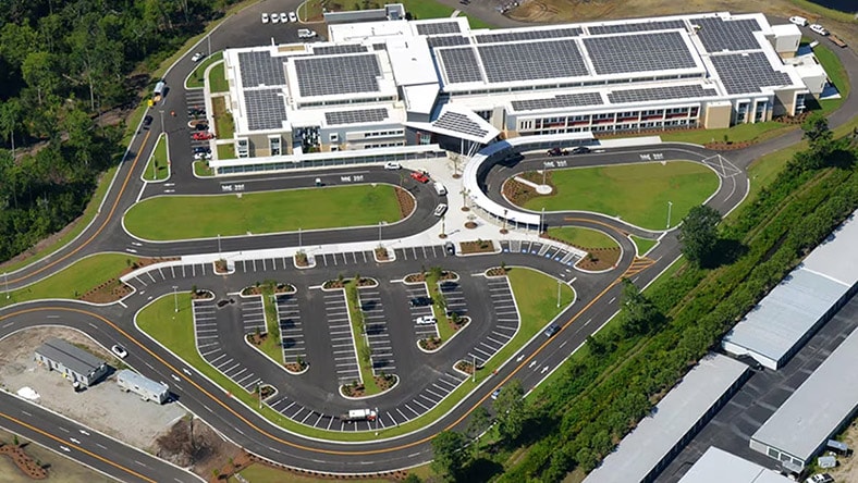 An overhead view shows a modern school campus.