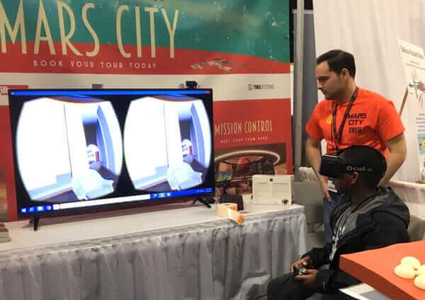 Architect Rolando Lopez and a student getting a Mars City tour at the USA Science & Engineering Festival in Washington DC