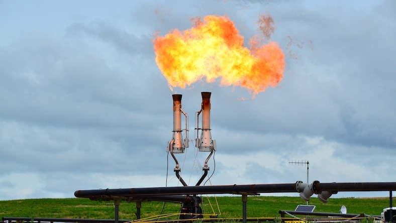 Pipes in an open field venting burning gas.