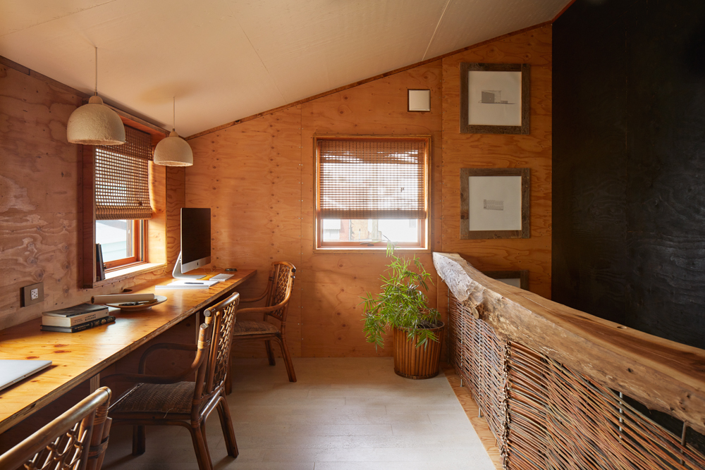 Interior of Grass House with built in desk and MushLume pendant lamps