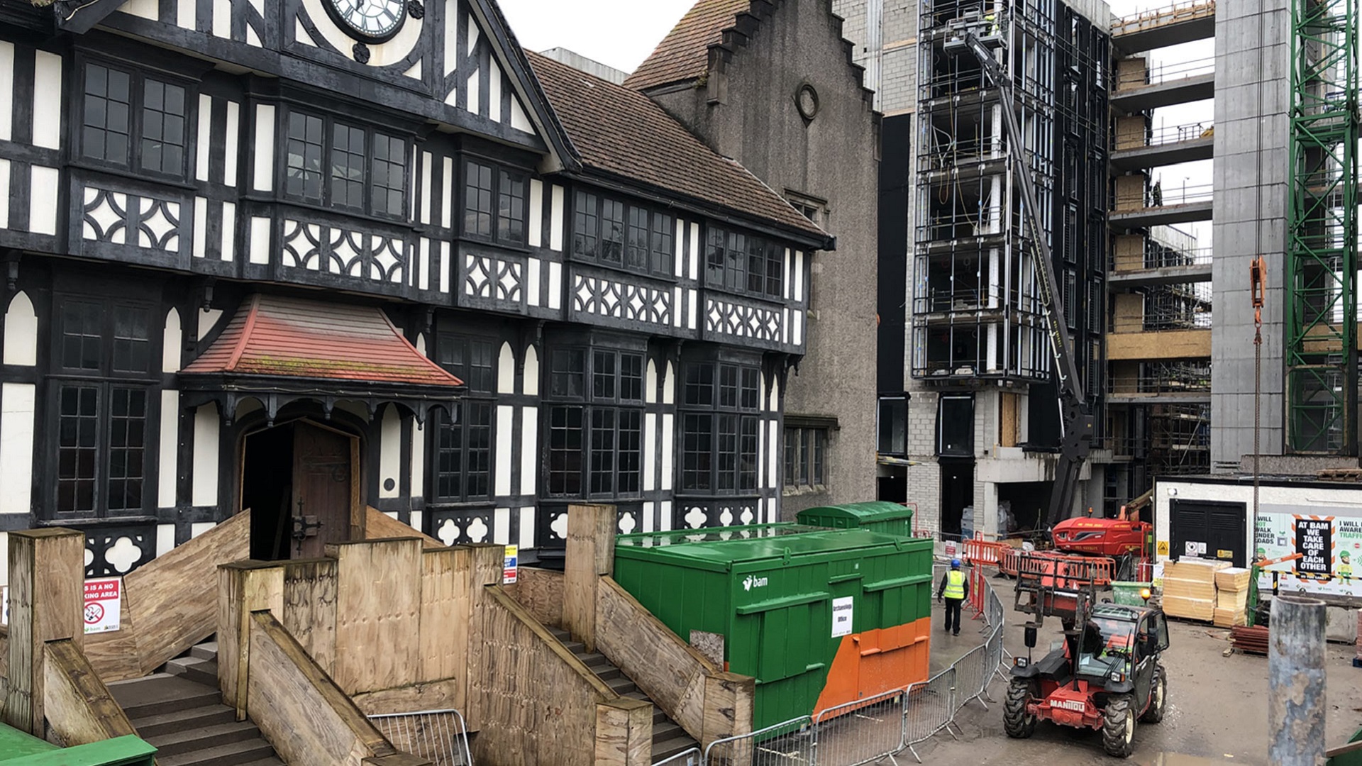 A 17th-century building in Cork, Ireland sits next to the construction site for a modern high-rise building.