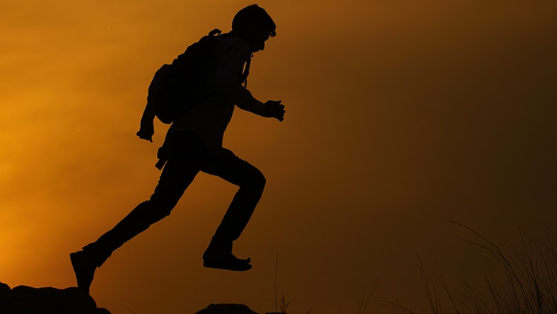 A man’s silhouette running.