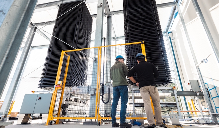 Two workers examine Heirloom's direct air capture (DAC) equipment to remove carbon dioxide from the atmosphere. 