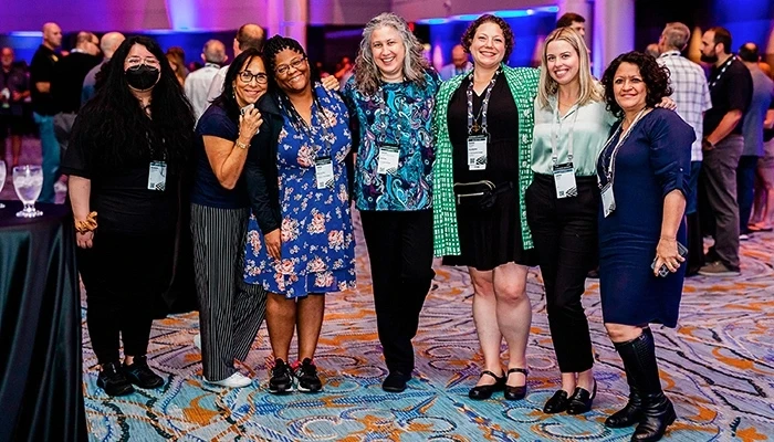 Female Autodesk University attendees pose for a photo.