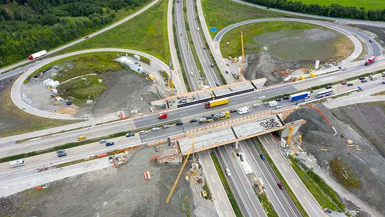 An aerial view shows the reconstruction of a highway interchange.