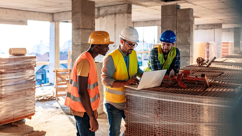 Engineer, architect and business man working on the engineering project at construction site.