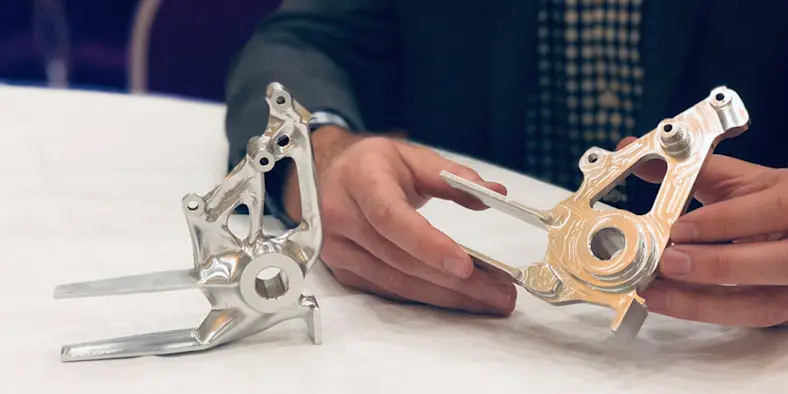 Hands holding machined parts generative design manufacturing automation