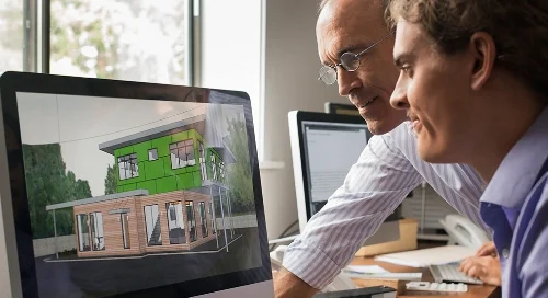 Two people looking at a rendering of a building