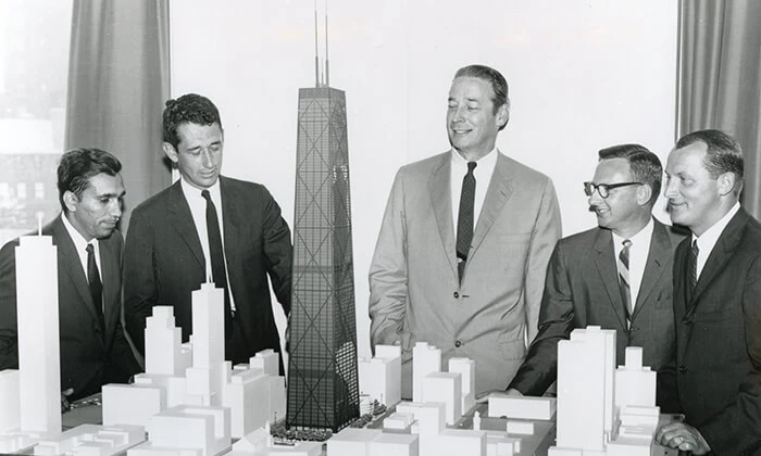 Architects surround a model of the Hancock Center.