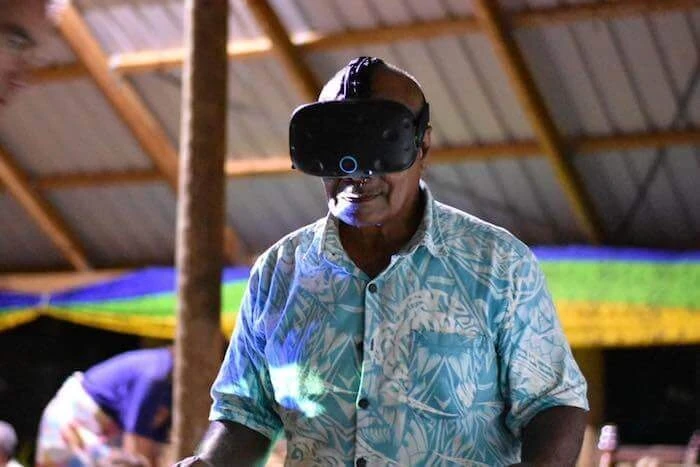An older man wears VR goggles.