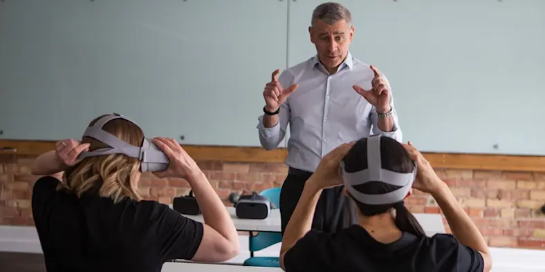 Workers don VR goggles in a VR training in the workplace