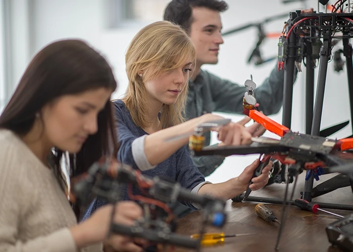 women work on machinery