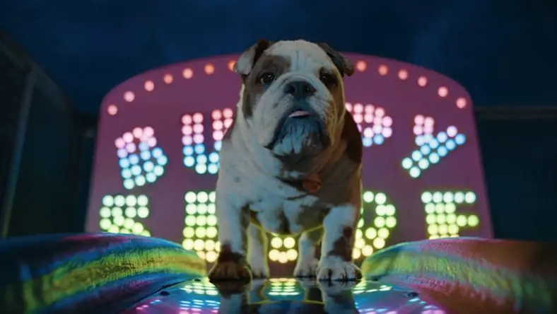 A computer-generated bulldog is lit by Broadway-style lights.
