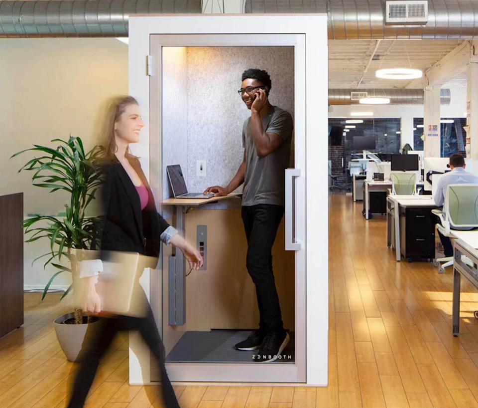 Photo of an employee in an office using a Zenbooth privacy pod created with Autodesk Fusion.