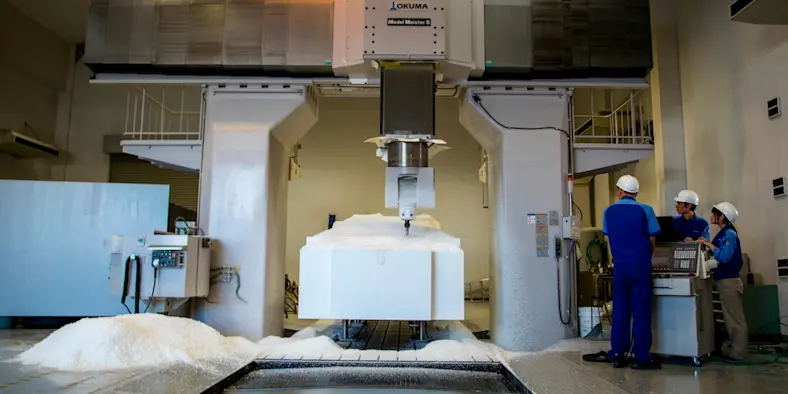 Workers milling a full-sized foam prototype of a car chassis using a CNC machine Nichinan Group in Japan