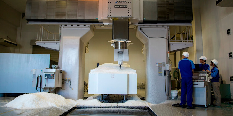 Workers milling a full-sized foam prototype of car