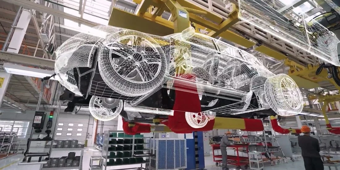 Image of an auto factory with a digital overlay of a car