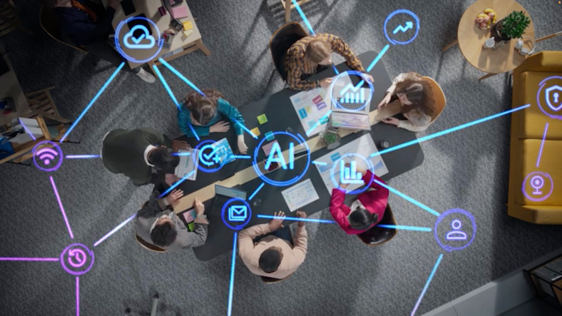 An overhead view of people working together at a table is overlaid with icons representing AI and data connections.