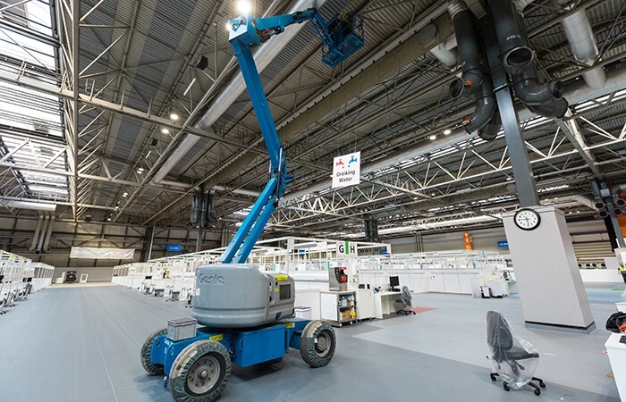 A crane positioned next to hospital equipment at Nightingale Hospital construction 