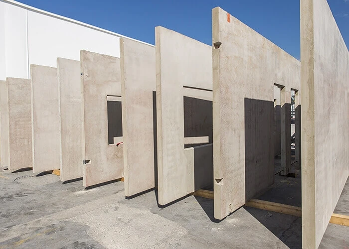 Concrete walls with window and door frames in the final curing phase