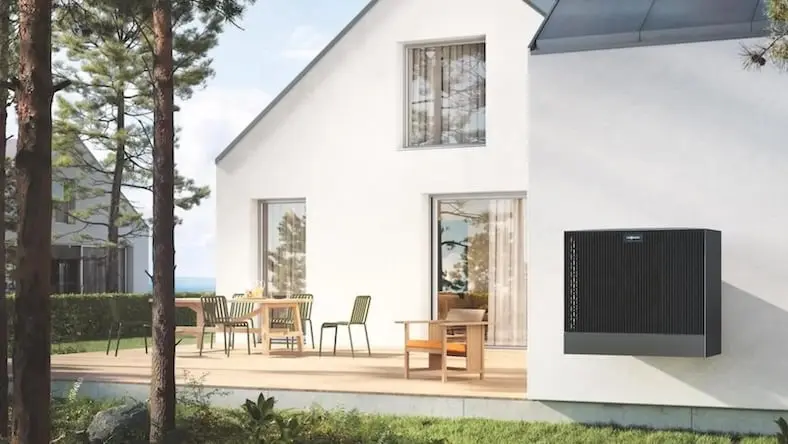 A view of a heat pump on the exterior of a modern house.