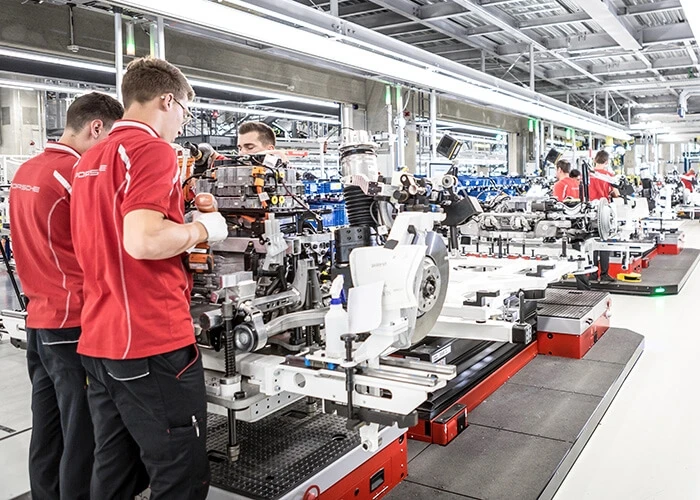 Workers on the line at the Porsche Taycan factory