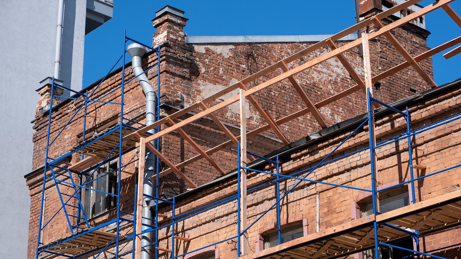 An old brick building is being restored to preserve its architecture. 