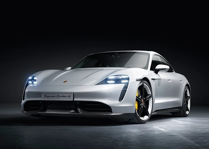 Press shot of a silver/white Porsche Taycan